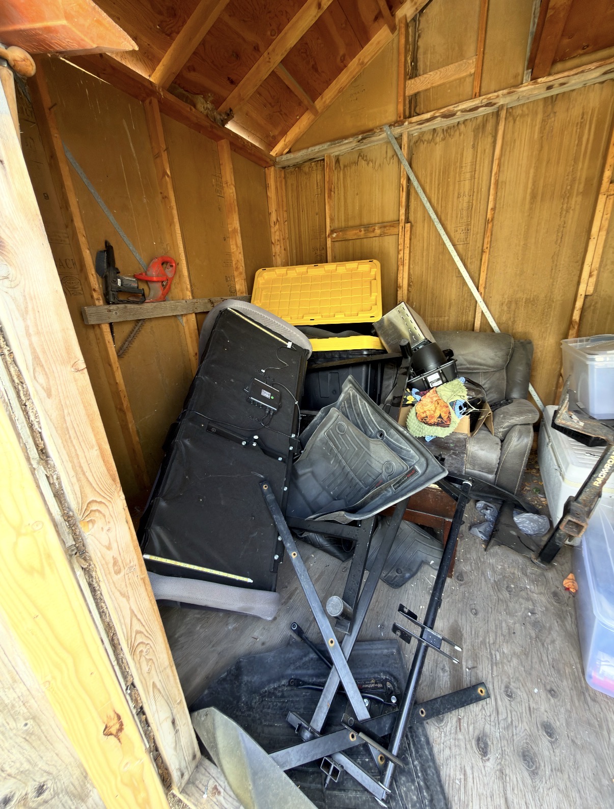 Packed shed full of old junk and clutter before removal in Salt Lake County